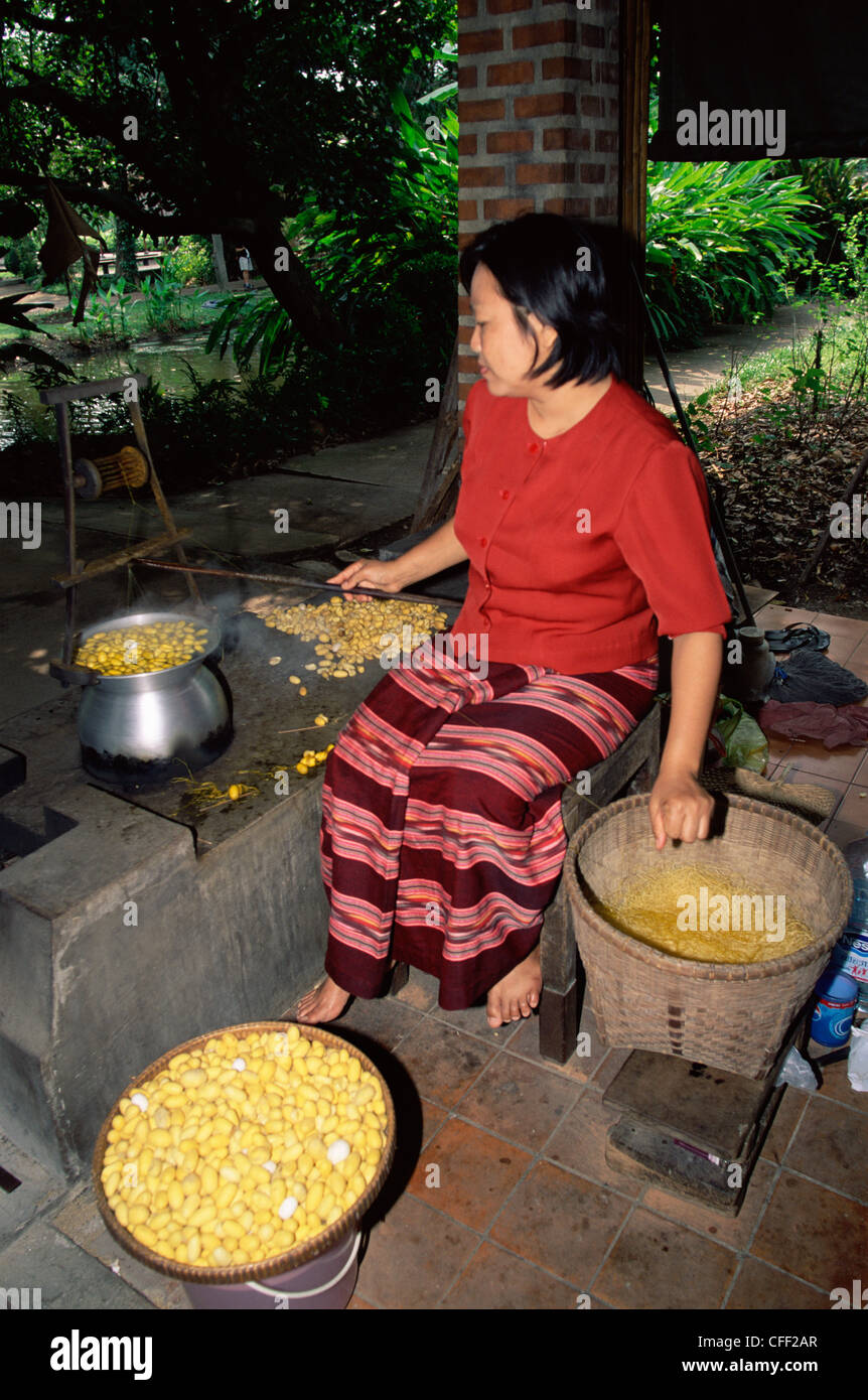 Thailand, Bangkok, Woman Demonstrating Silk Thread Making at The Rose Garden Stock Photo