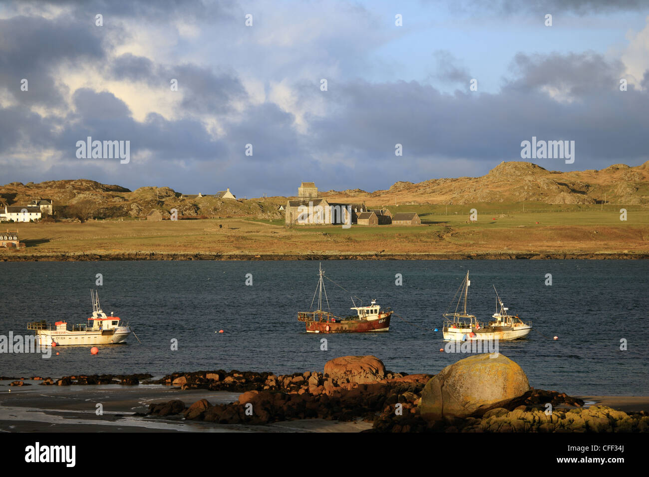 Cloudy skies over Iona and Iona Abbey taken from Fionnphort on the Isle of Mull Stock Photo