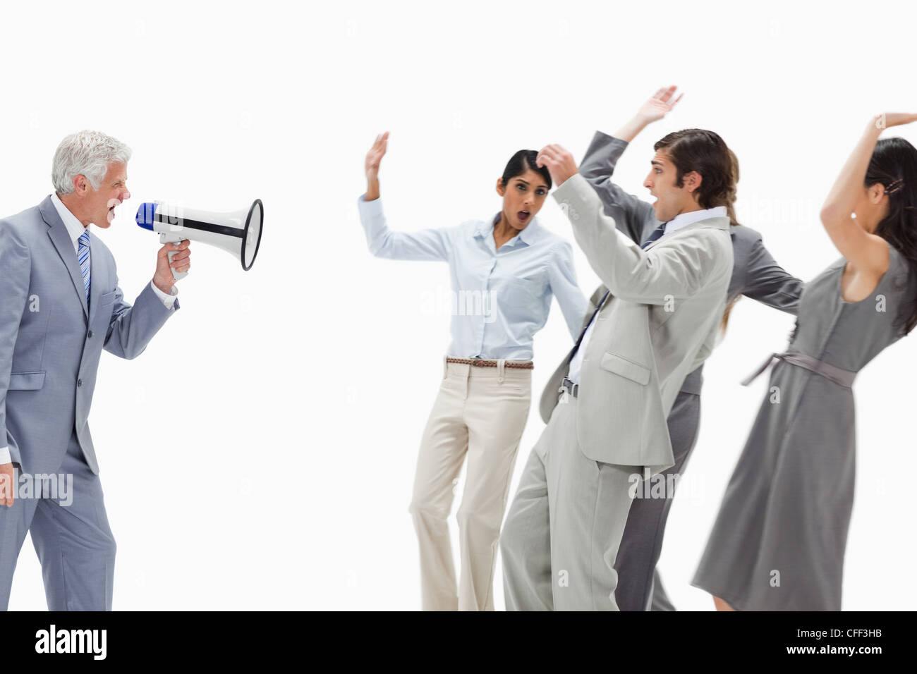 Man yelling in a megaphone at business people Stock Photo
