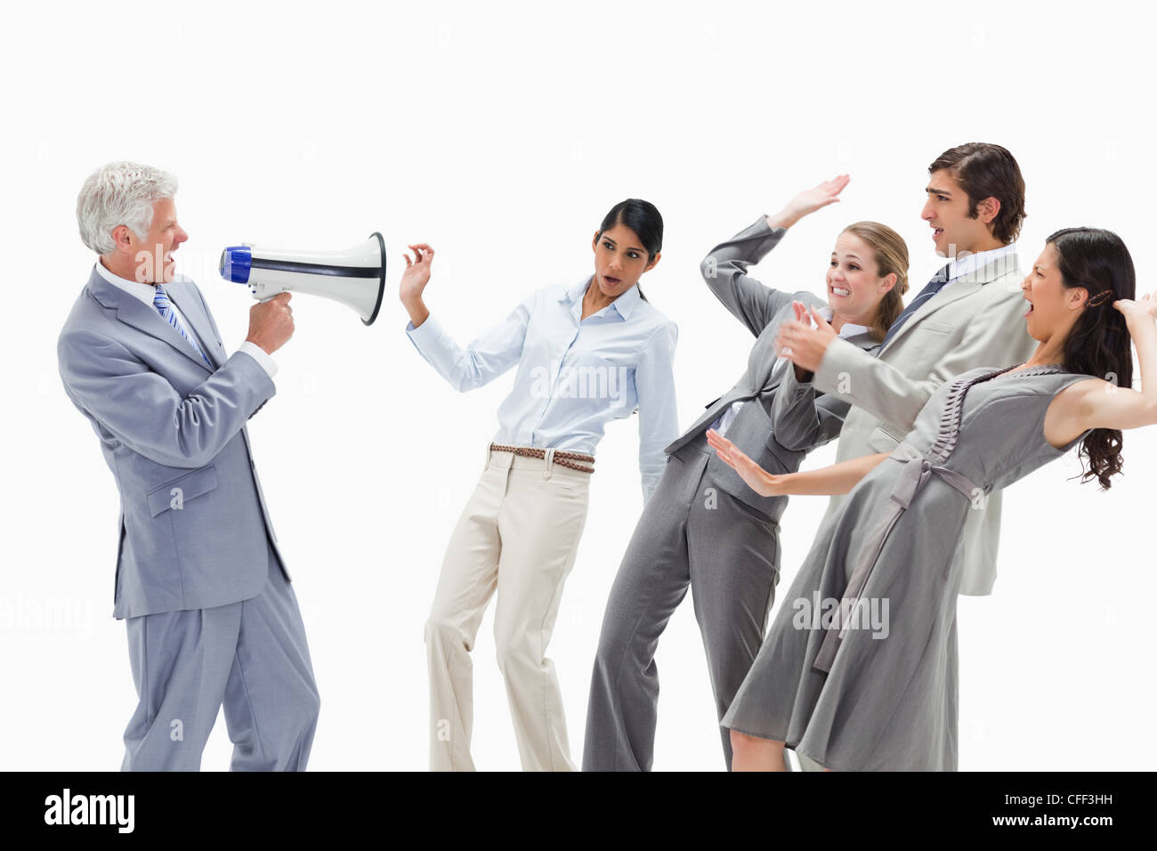 Man yelling in a megaphone at stunned business people Stock Photo Alamy