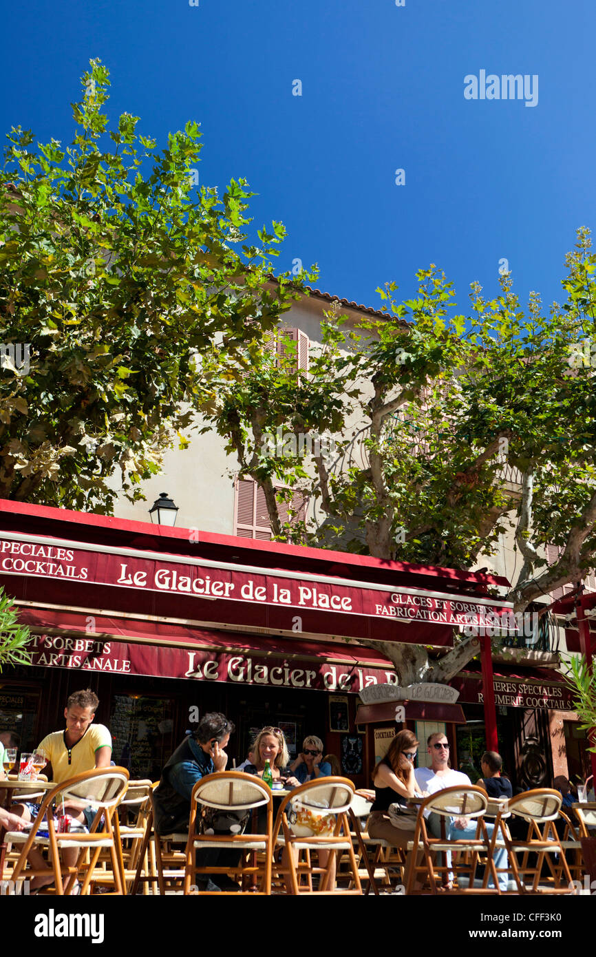 Crowds sitting in a street café, Place de la République, Porto Vecchio, Corsica, France Stock Photo