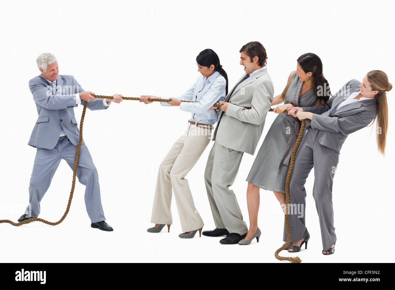 Business people pulling a rope against their boss Stock Photo