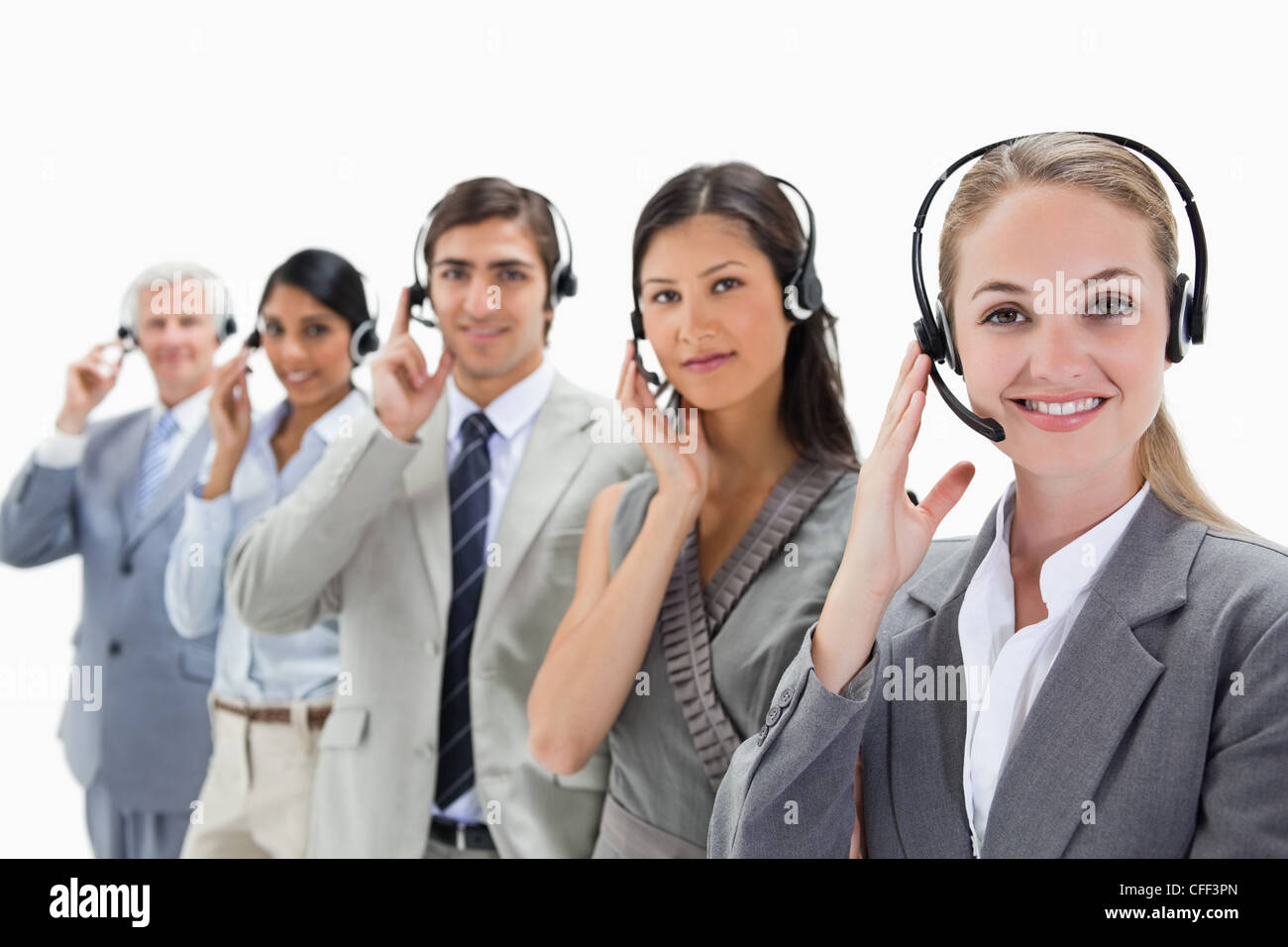 Professionals listening and smiling with headsets Stock Photo