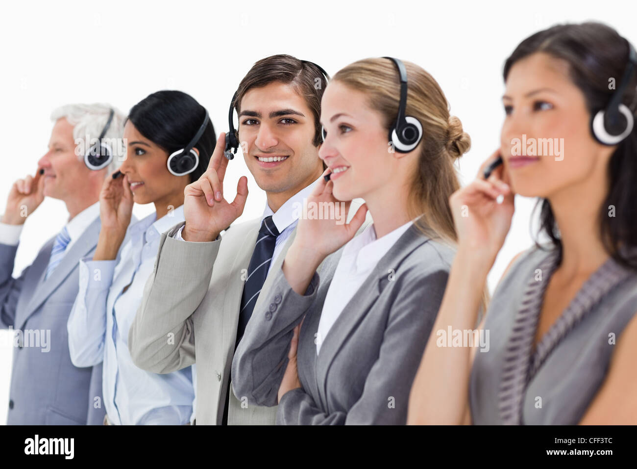 Smiling professionals in suits listening Stock Photo