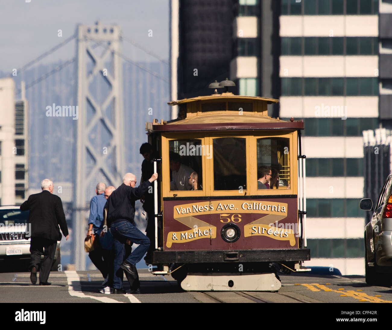 Cable car on Nob Hill along California Street, with west span of the Bay Bridge, San Francisco, California, USA Stock Photo
