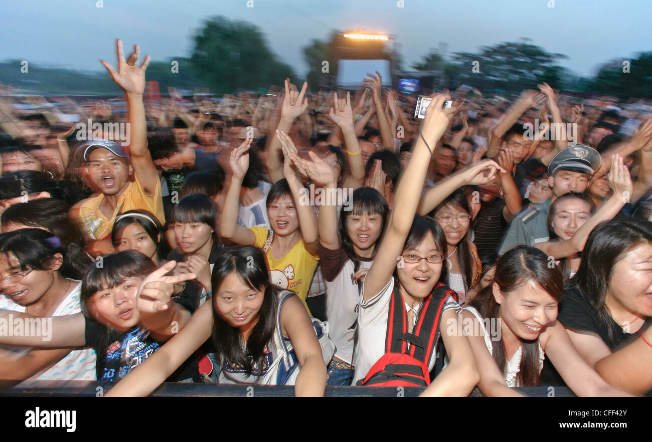 Young Chinese persons cheering at a rock and roll concert, Beijing ...