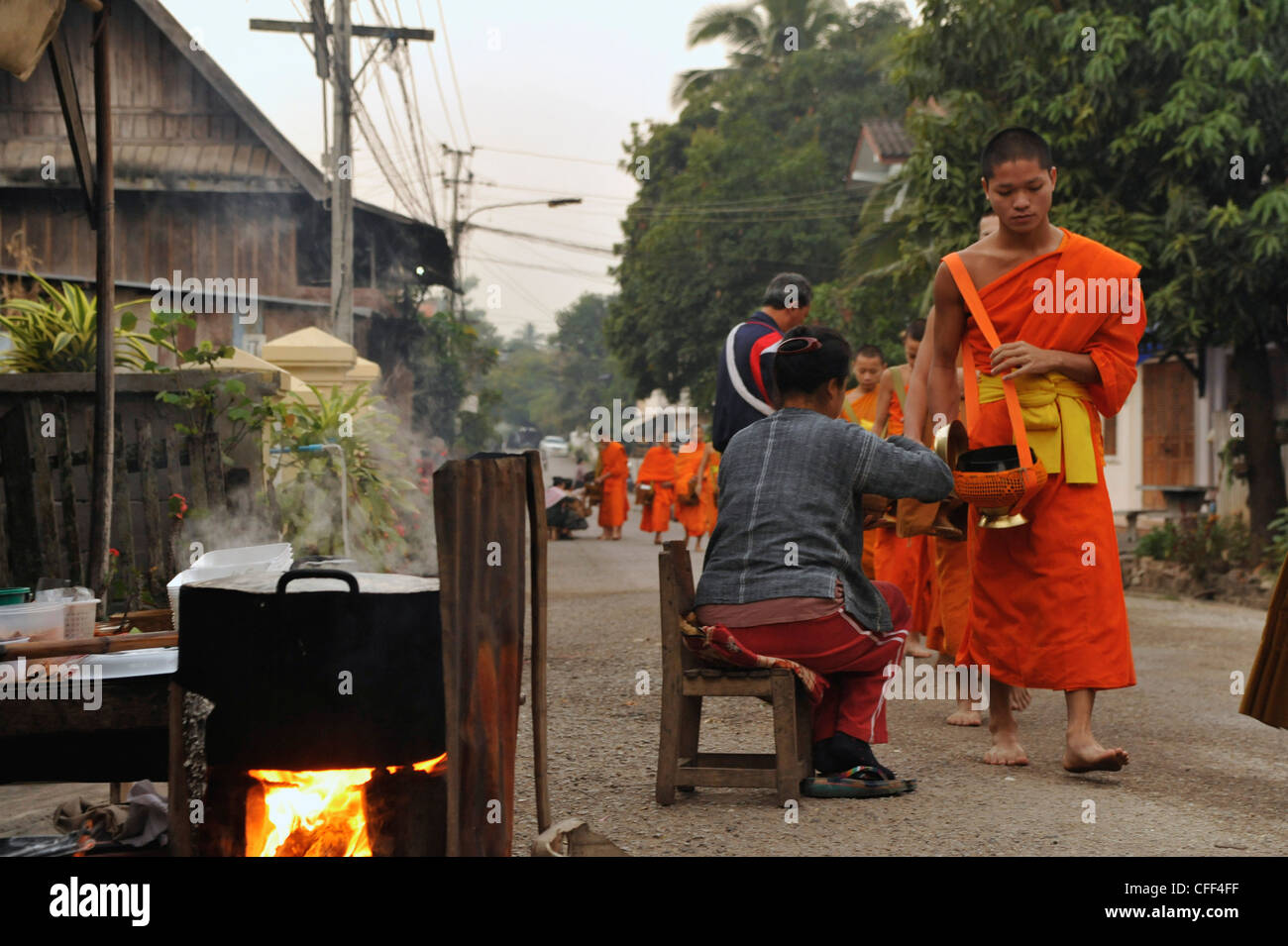 Monks collecting alms before sunrise, Luang Prabang, Laos Stock Photo