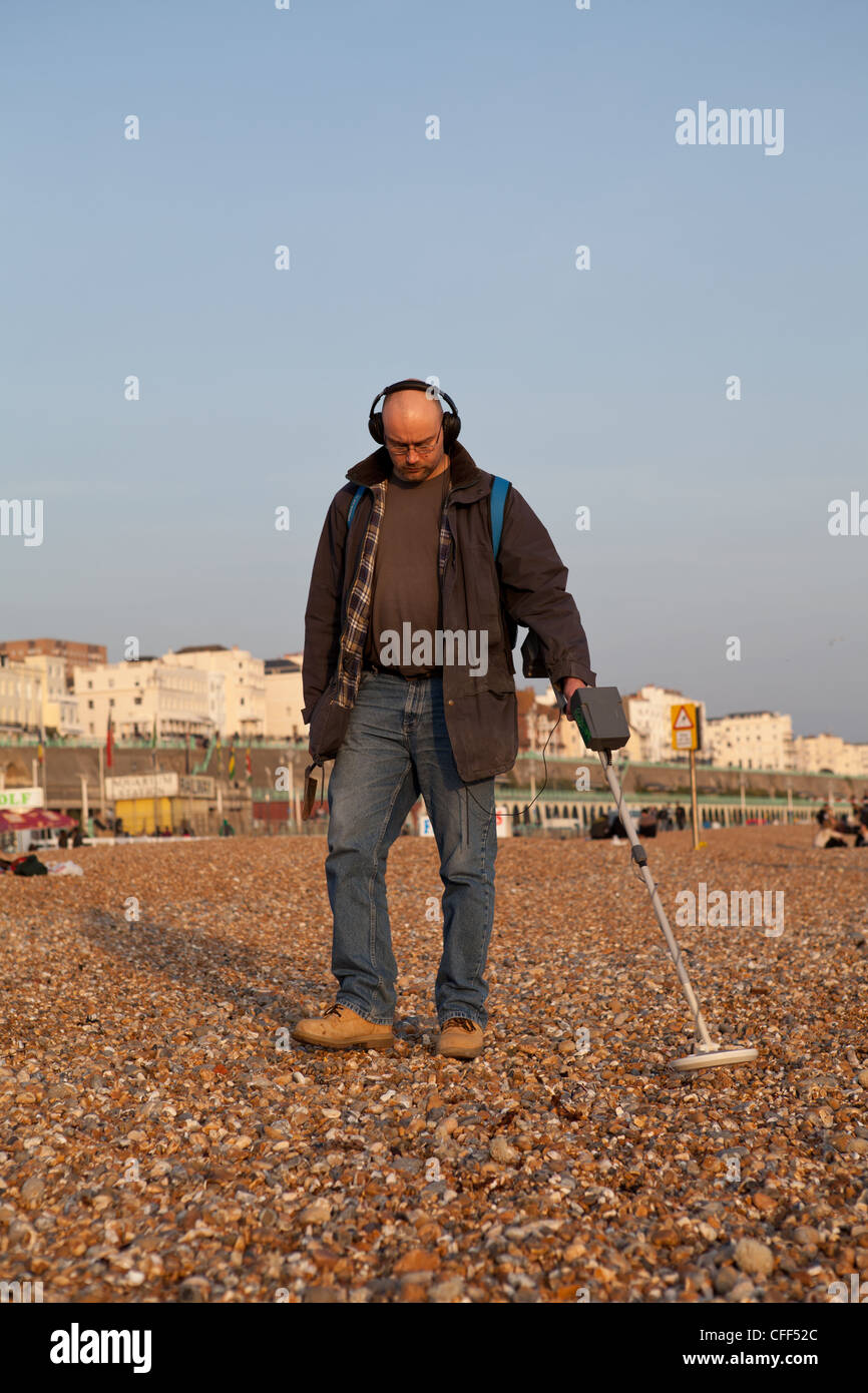 Man with metal detector on the beach in Brighton Stock Photo Alamy