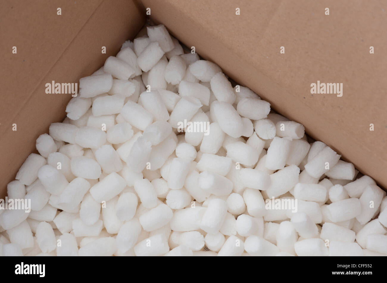 Cardboard carton filled with polystyrene foam chips Stock Photo by  ©willeecole 24136457