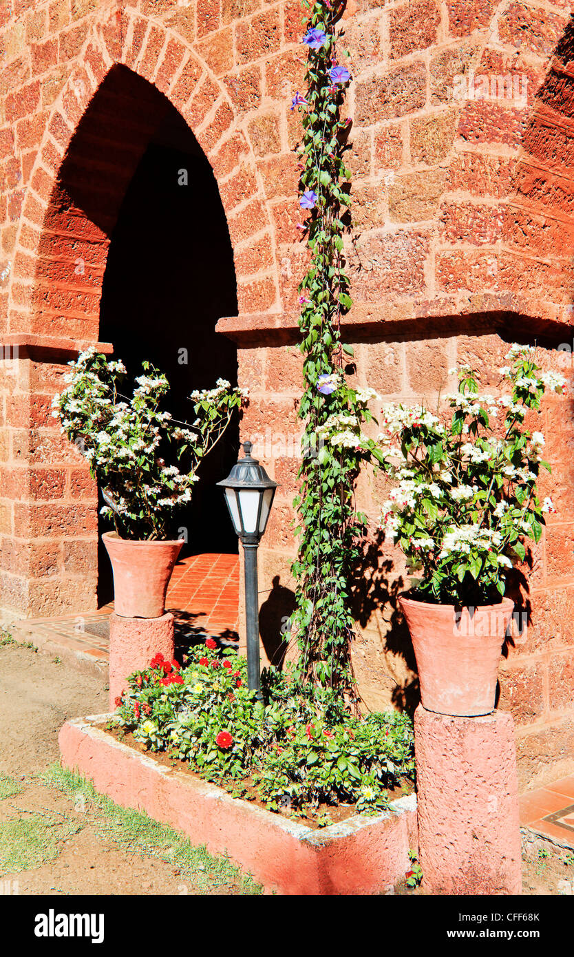 portrait of red brick built property detailing arch and patio areas leading to gardens, early 19th century styling Stock Photo