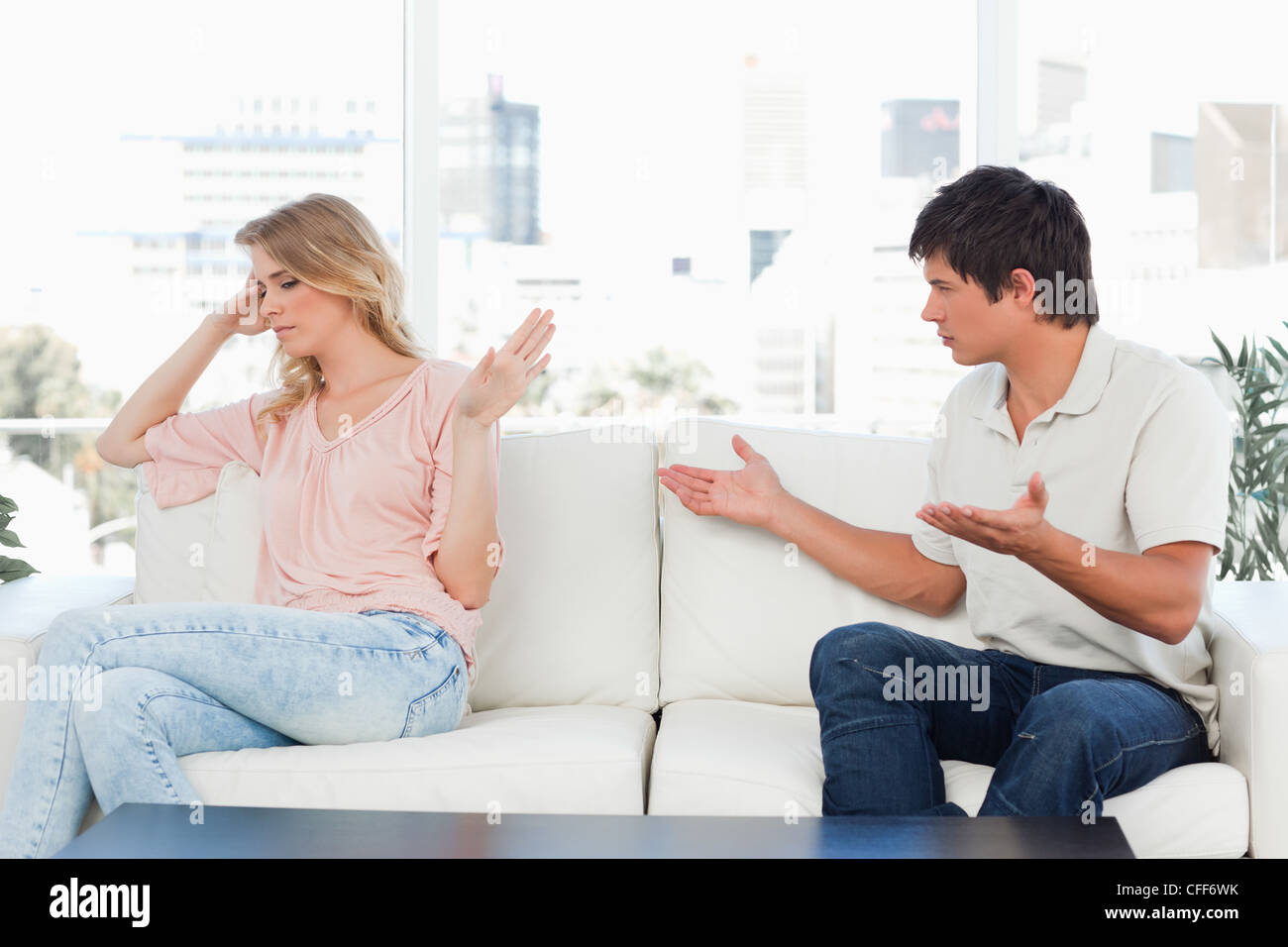 Man trying to apologise but the woman is not interested in it Stock Photo
