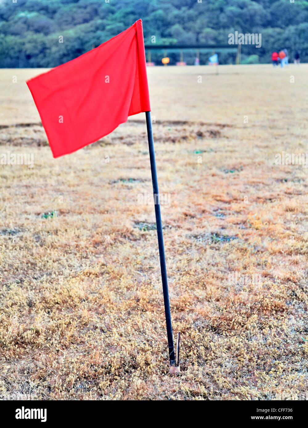portrait of red flag on golf drive range in India, colored flags marking 100 metres Stock Photo