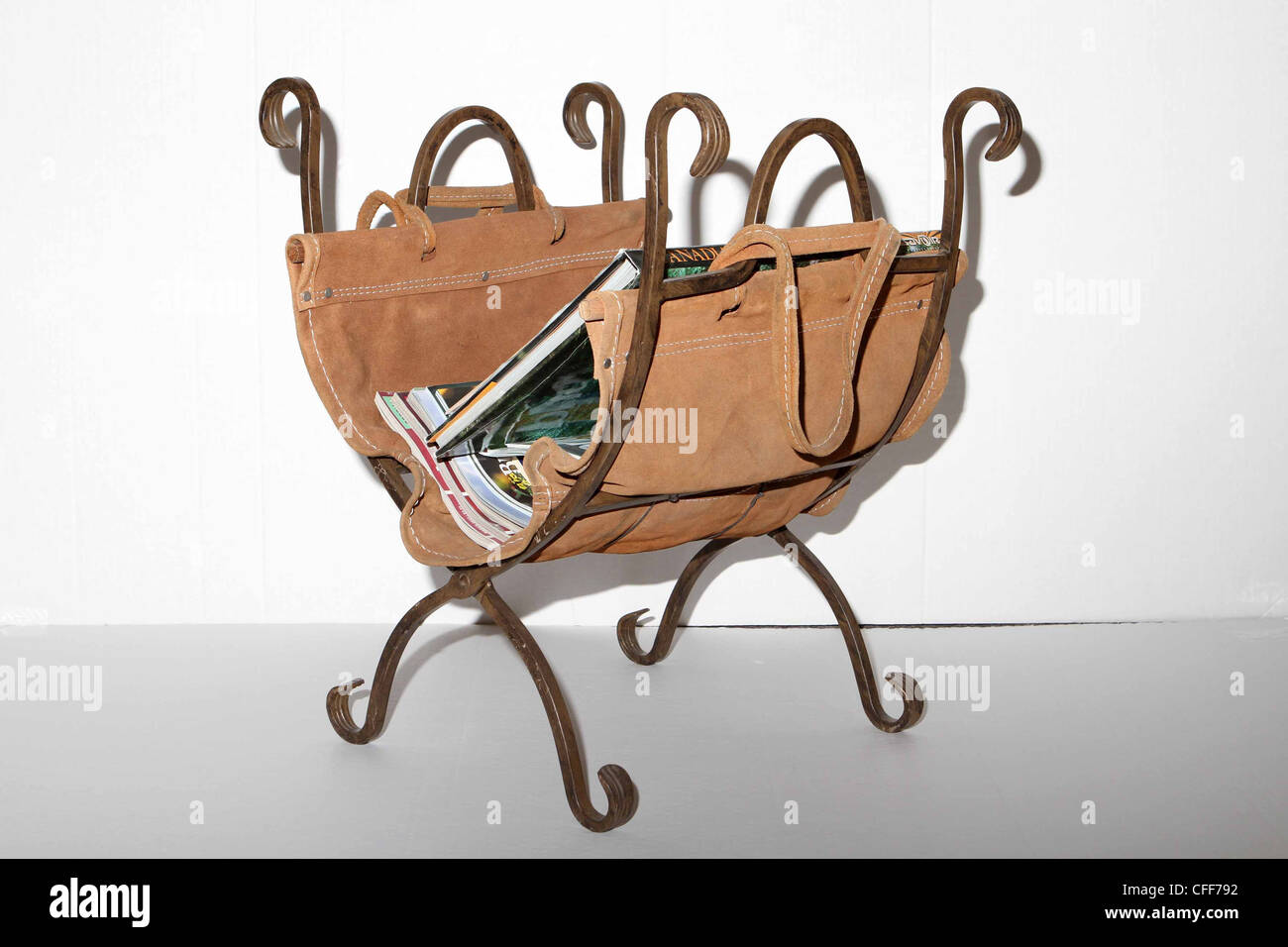 Leather and wrought iron magazine rack or fire wood holder Stock Photo