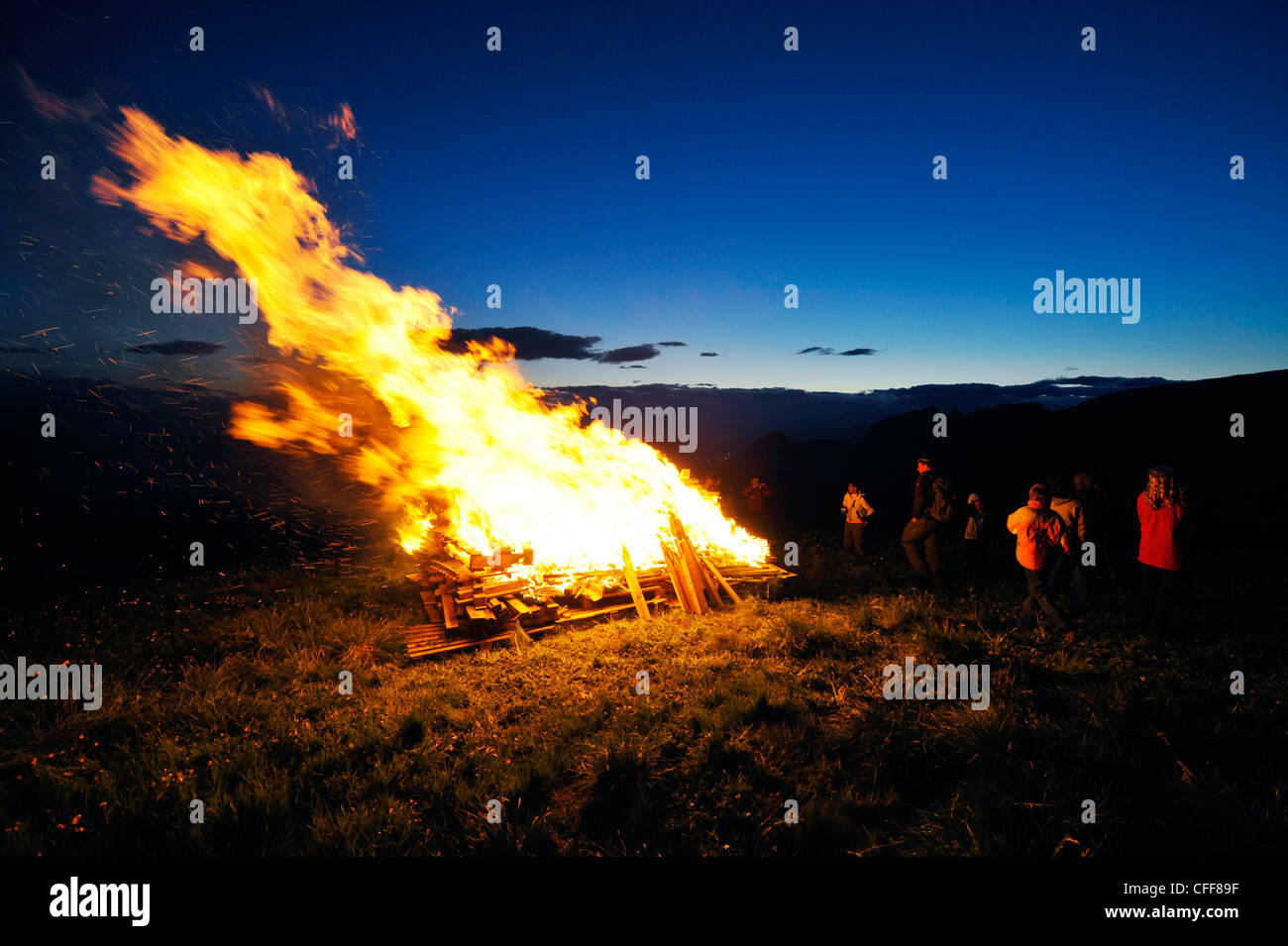 People at sacred heart fire in the evening, Val d'Ega, Karerpass, South Tyrol, Alto Adige, Italy, Europe Stock Photo