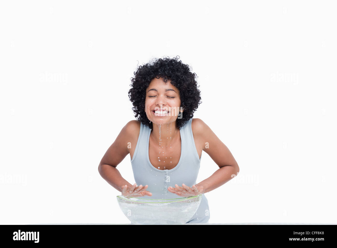 Young woman smiling after splashing her face with water Stock Photo - Alamy