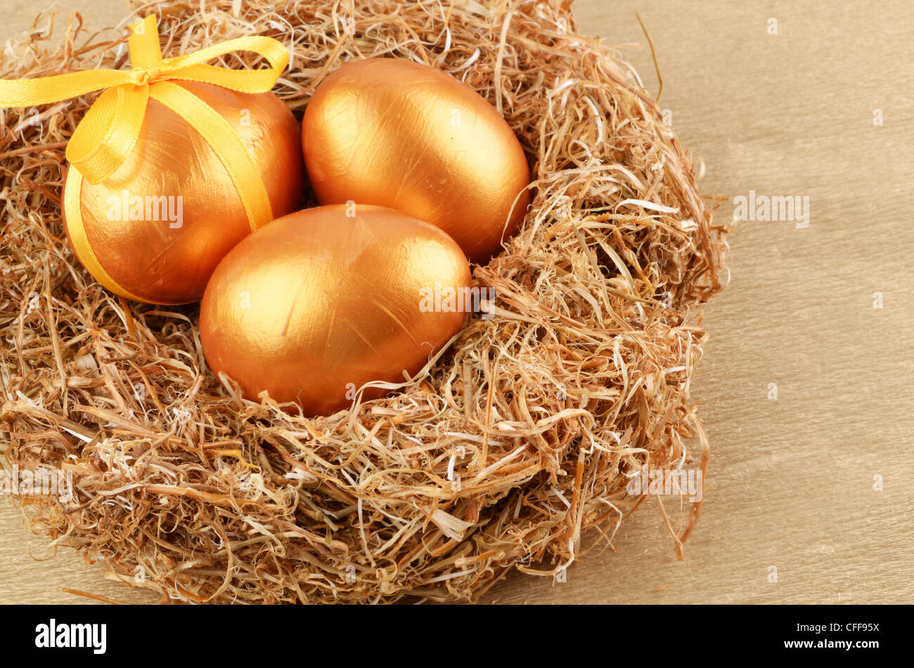 Golden Easter eggs in the nest over gold background Stock Photo - Alamy