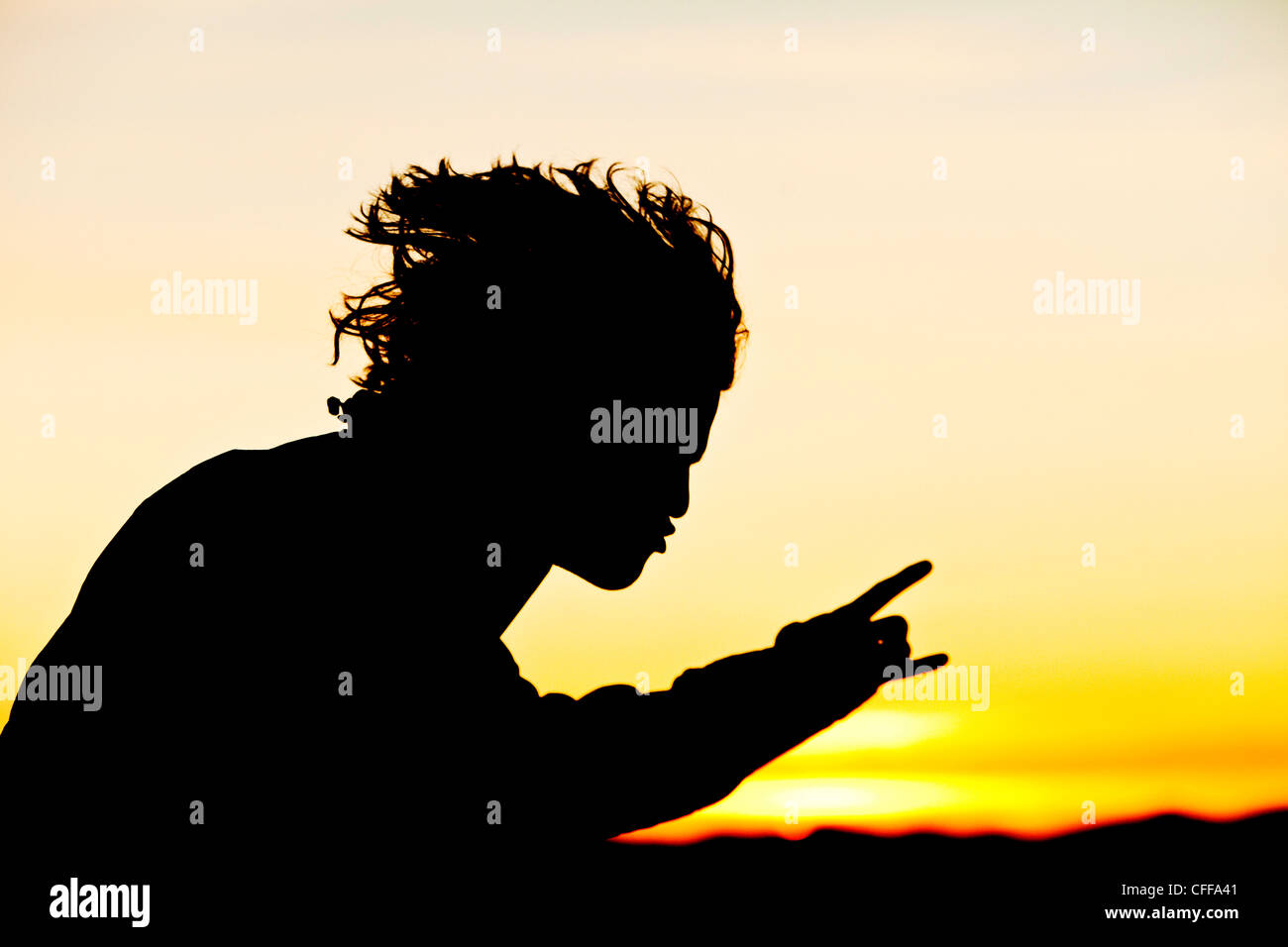 A young man rocking out at sunrise in Idaho. Stock Photo