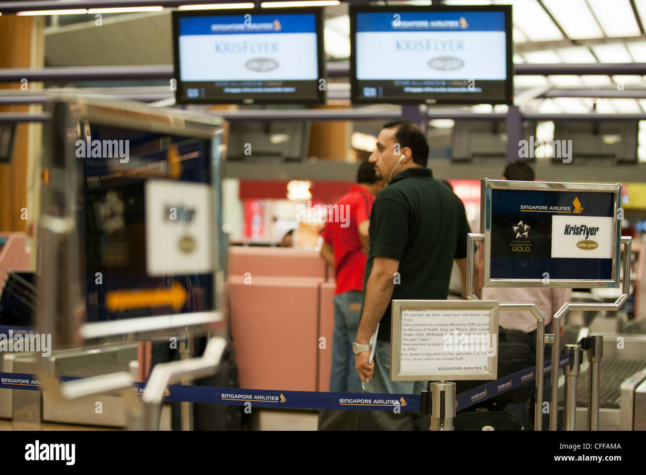 Passengers check-in for their Singapore Airlines Ltd. flight at Changi Airport in Singapore Stock Photo