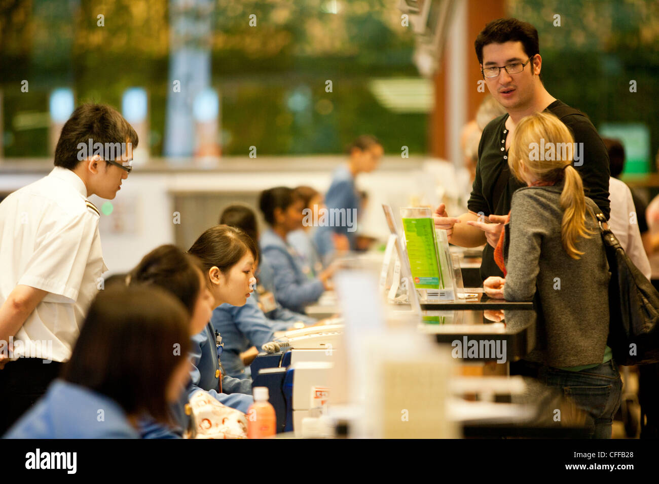 Passengers check-in for their Singapore Airlines Ltd. flight at Changi Airport in Singapore Stock Photo