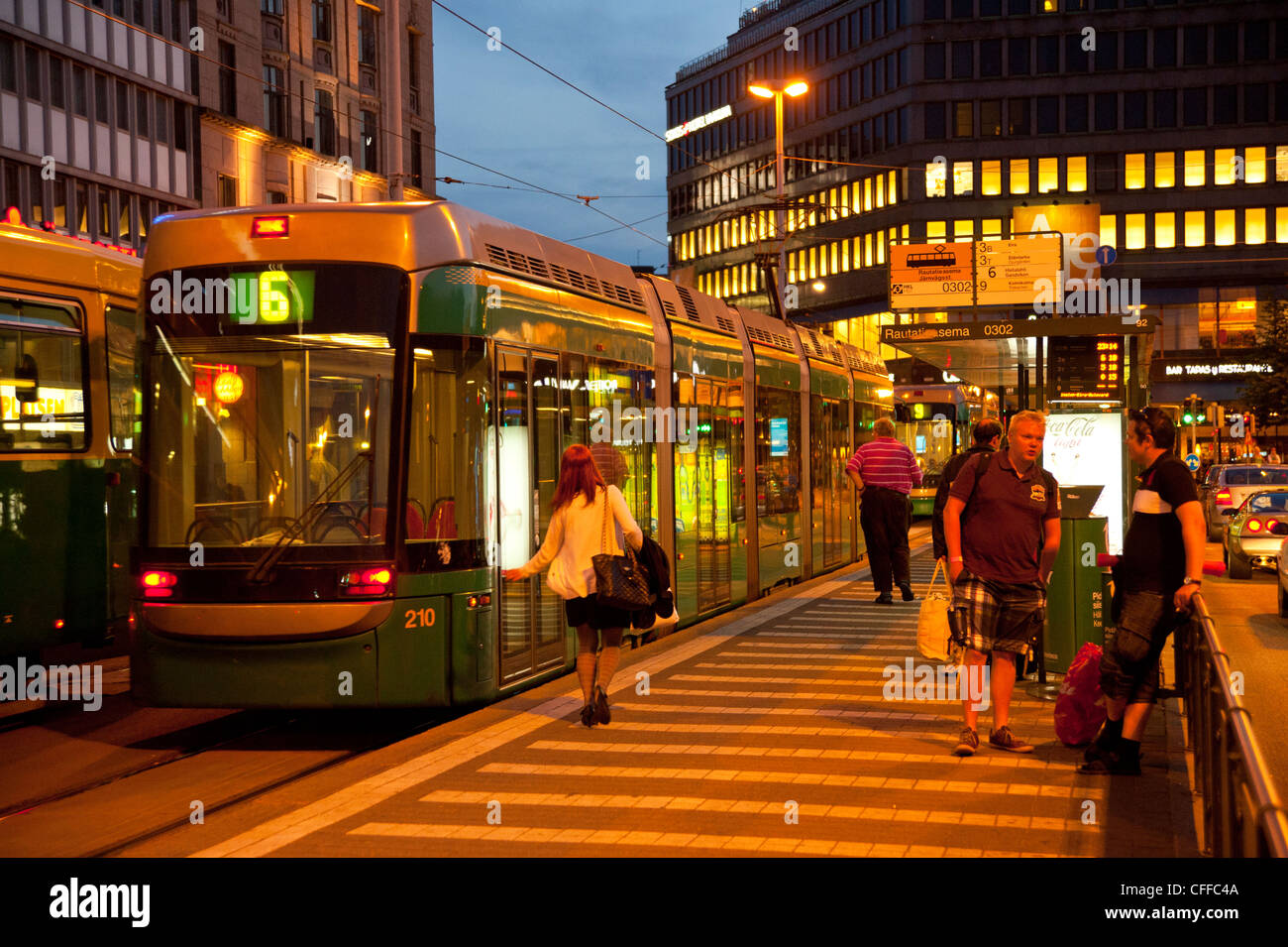 Trams at Rautatientori (Station Square) in Helsinki Finland evening Stock Photo