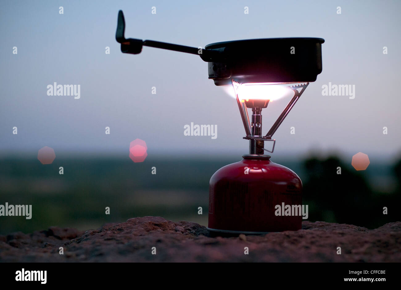 A camp stove illuminates the dusk evening on top of a bluff at Dynosaur State Park near Glen Rose, Texas. Stock Photo