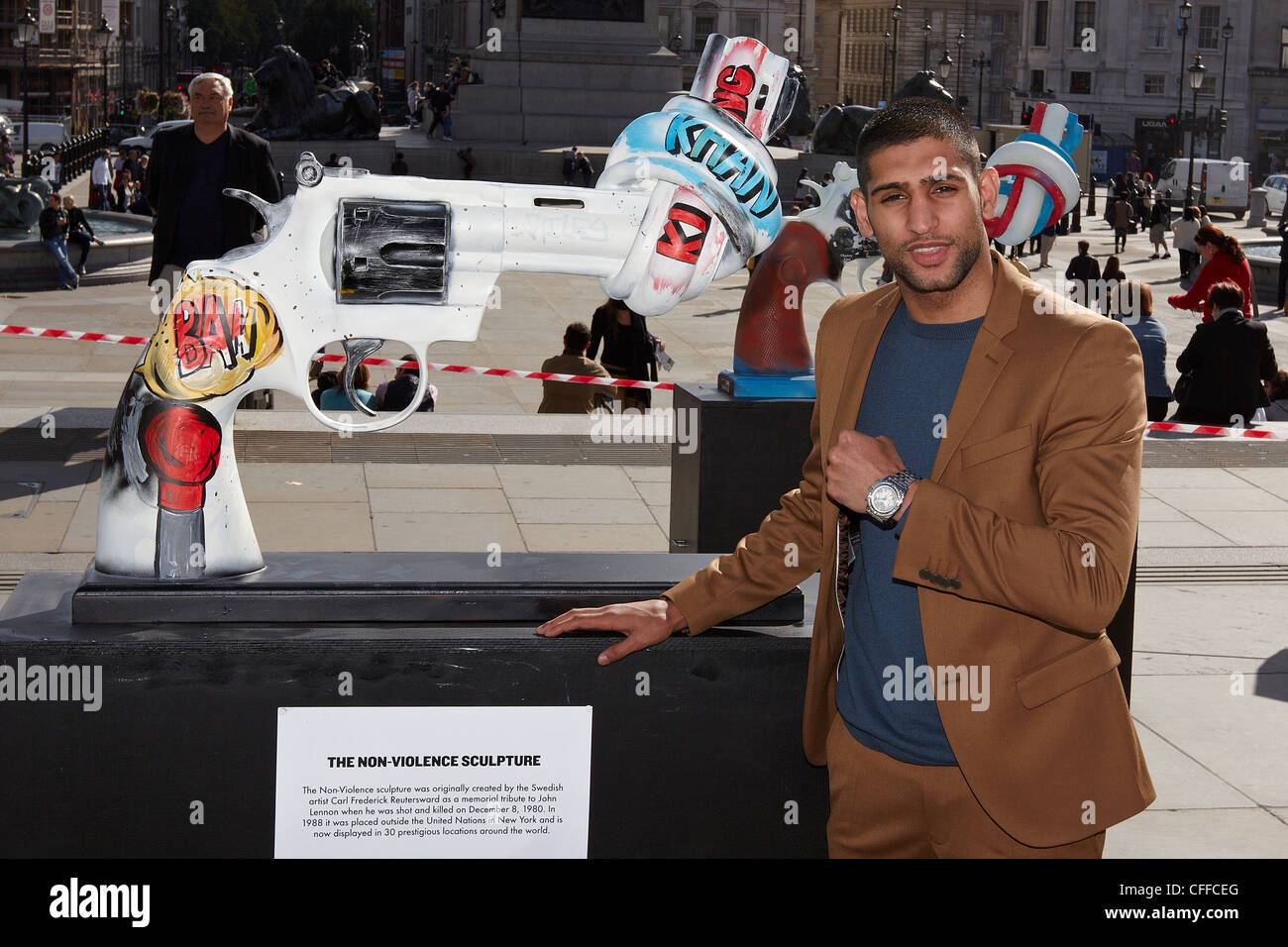 Boxer Amir Khan poses with a sculpture installed in Trafalgar Square as part of Non Violence Project's Knot Violence campaign Stock Photo