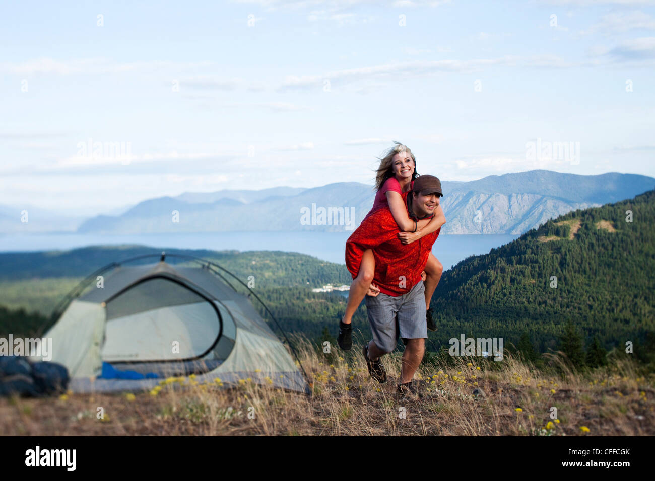 A happy couple smile and laugh on a backpacking and camping trip in Idaho. Stock Photo