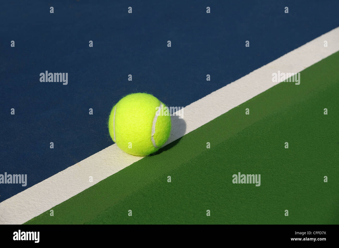 Tennis ball on the line Stock Photo
