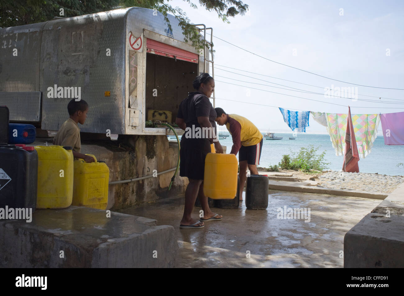 Sal Rei Boa Vista Cape Verde Local residents with no running water in home filling plastic containers from city water tank Stock Photo