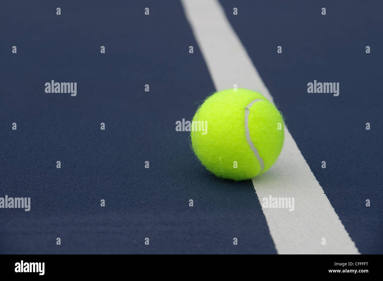 Tennis ball touching the line. Stock Photo