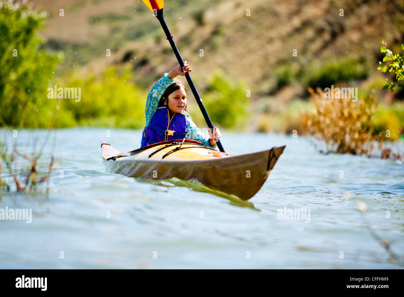 A woman paddles a wooden kayak, Bear Lake. Stock Photo