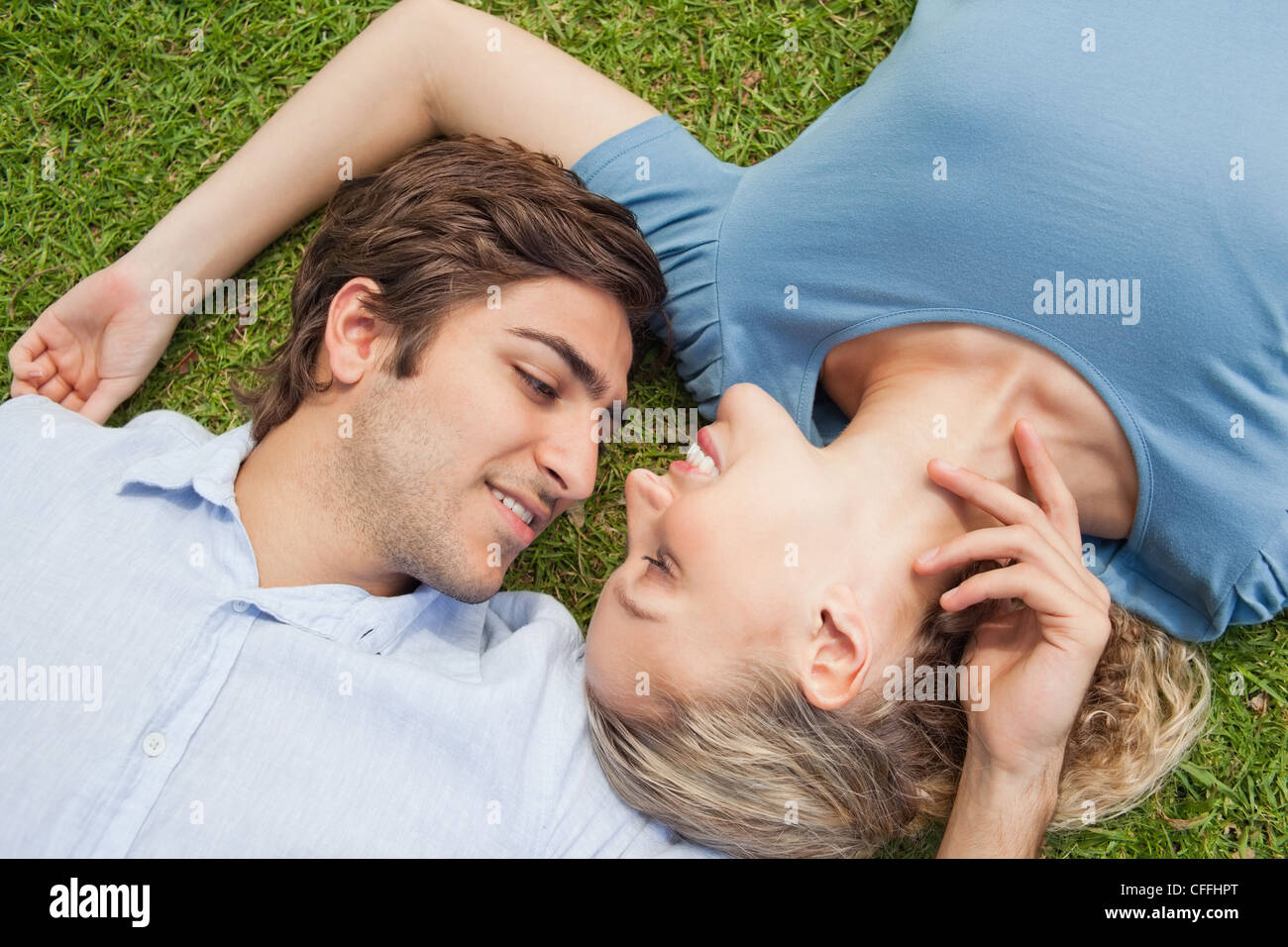 Couple relaxing on the lawn Stock Photo - Alamy