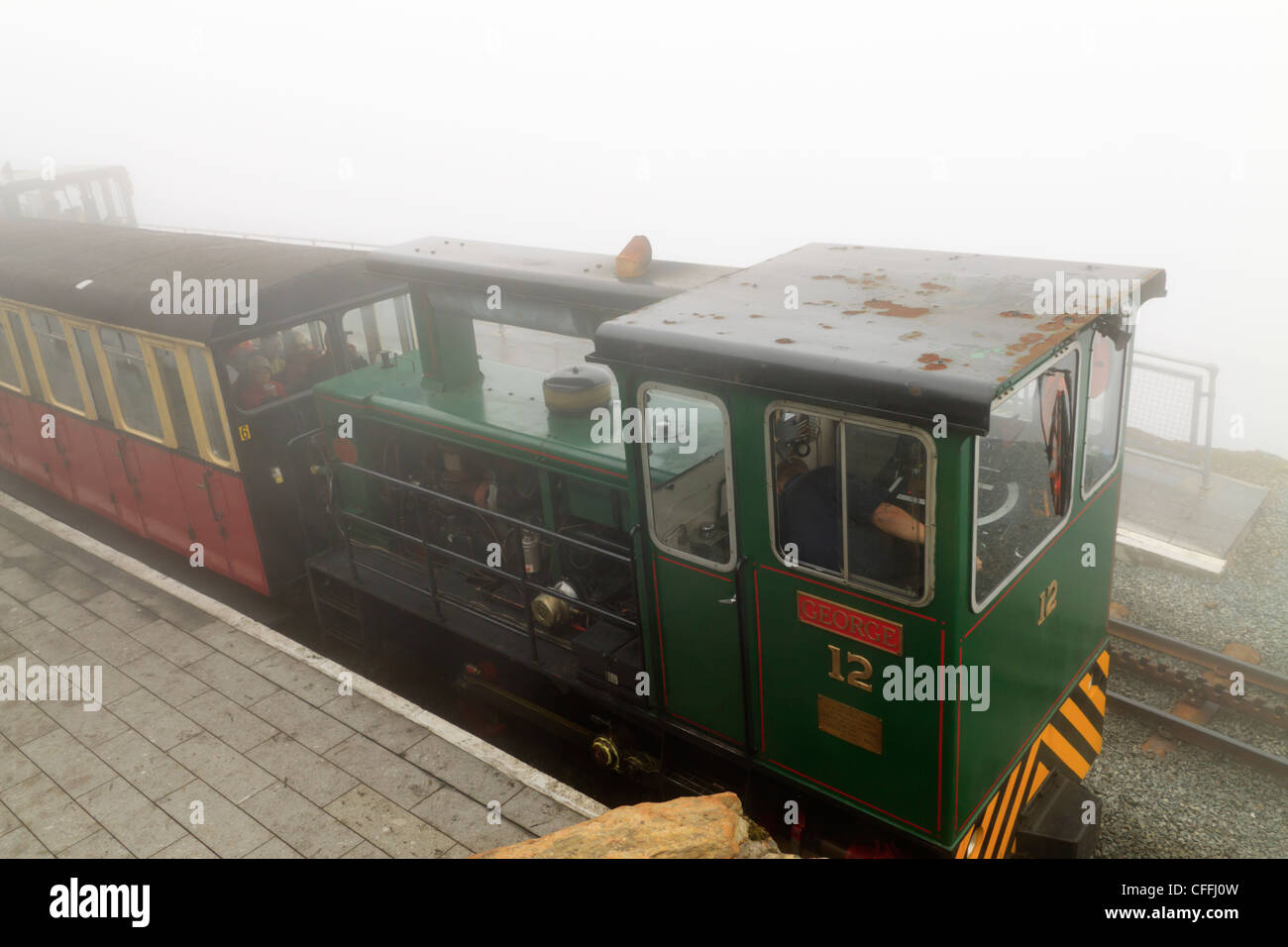 A Narrow Gauge Train at a misty Snowdon summit station Stock Photo