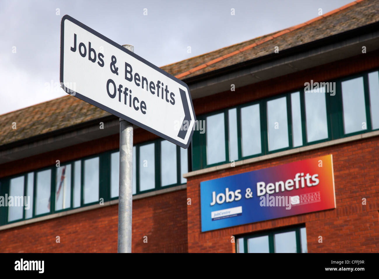 road sign pointing to jobs and benefits office antrim county antrim