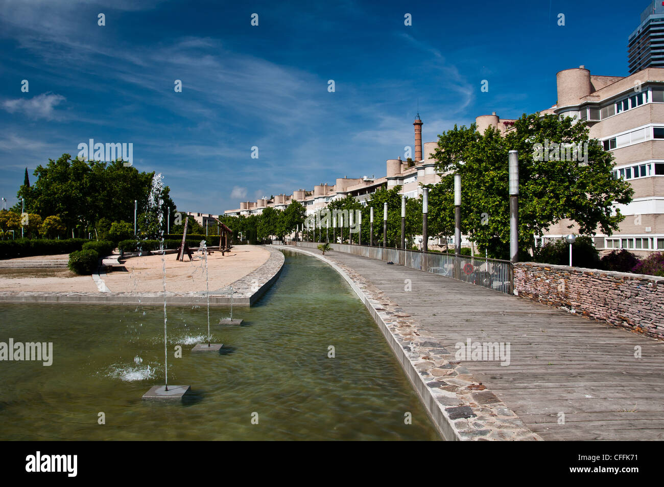 A residential neighbourhood with buildings in a row and a fountain. Stock Photo