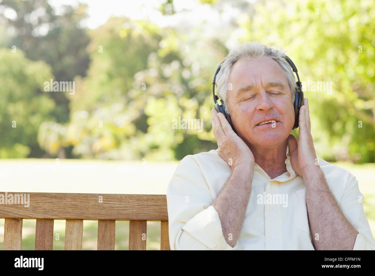 Man thoughtfully listennig to music Stock Photo