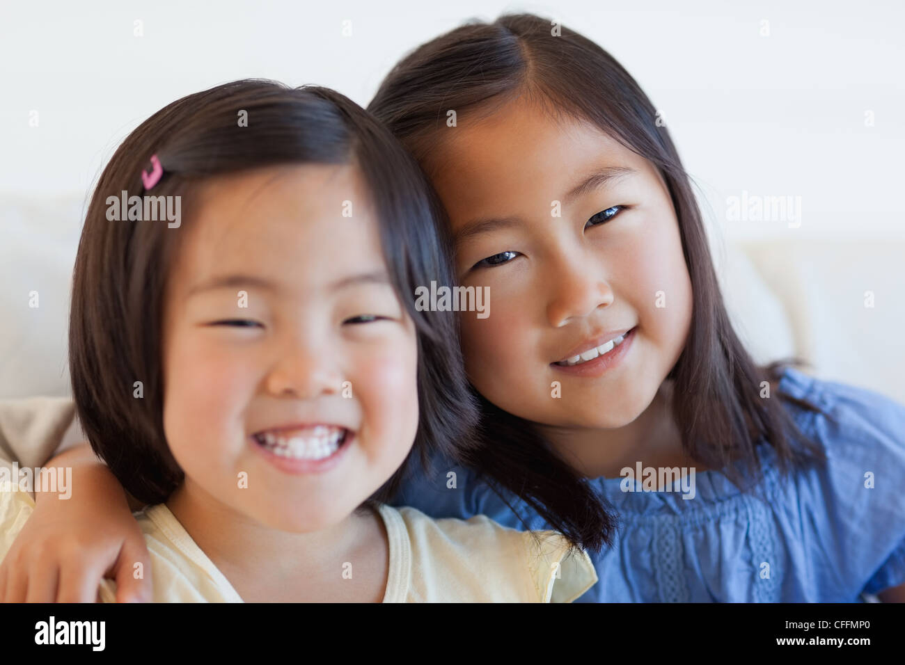 Two girls sitting on a sofa hi-res stock photography and images - Alamy