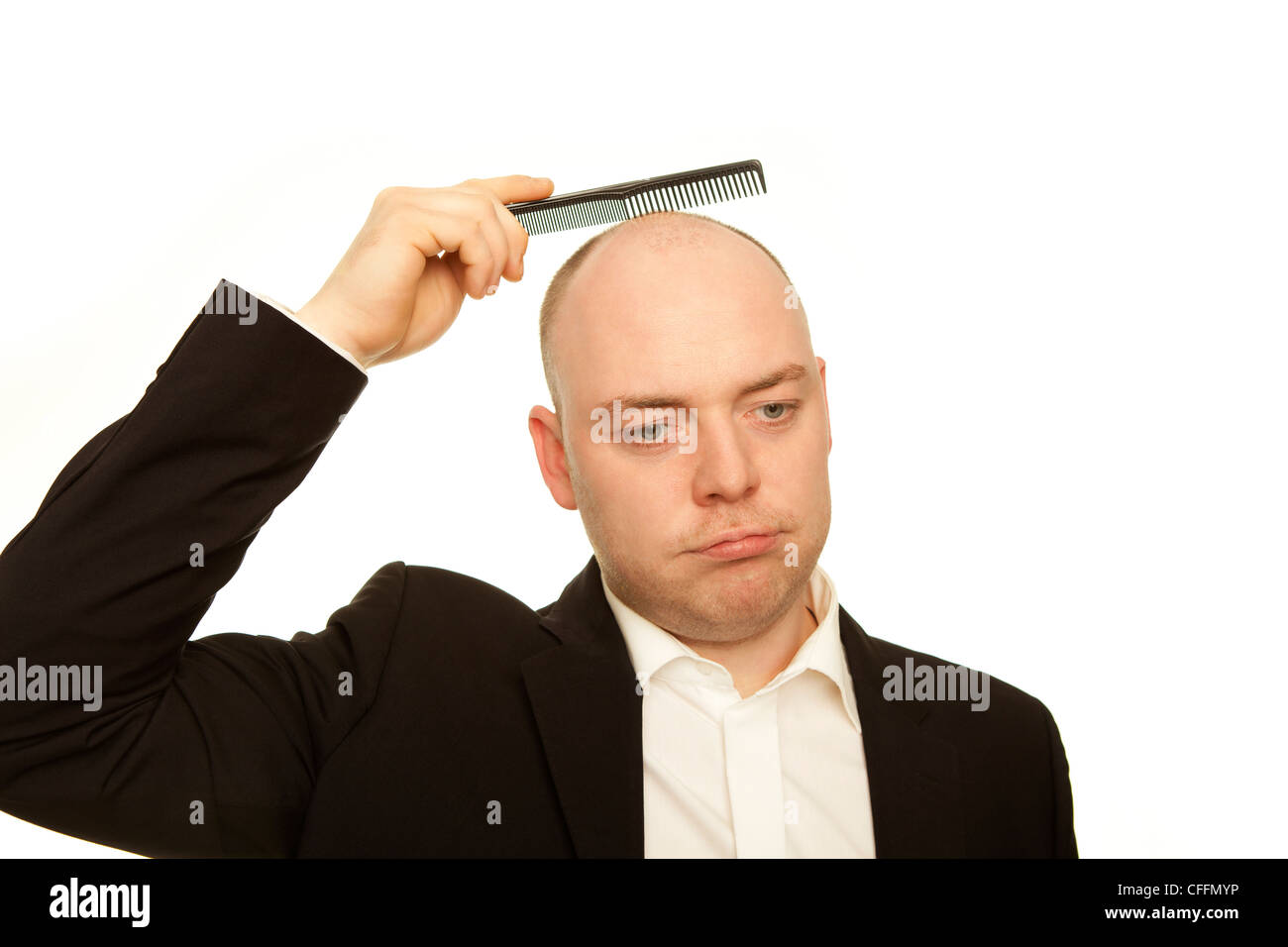business man with comb is sad about hair loss Stock Photo