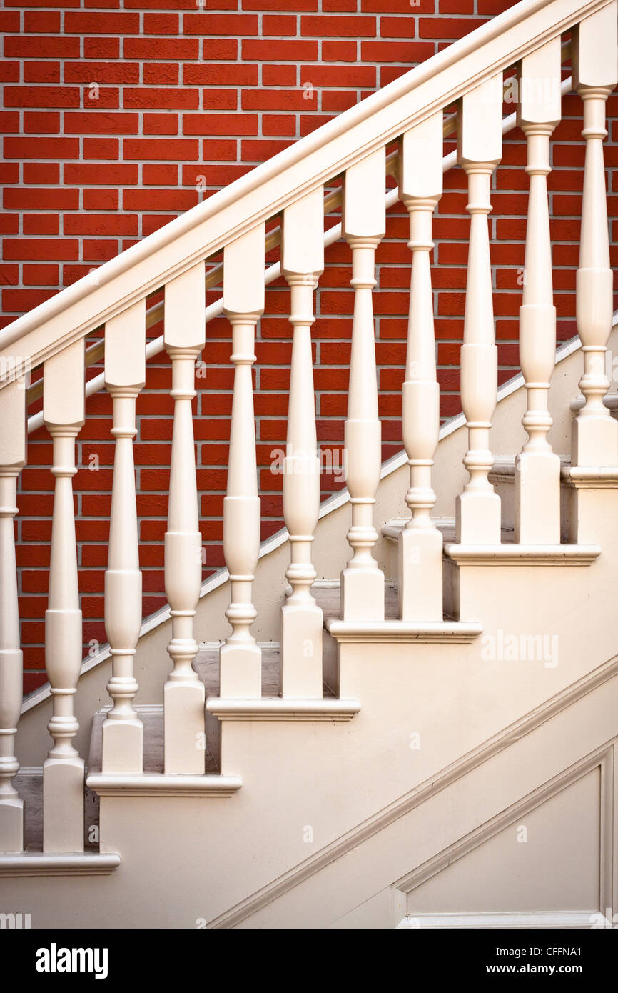 Background image of a traditional staircase against a red brick wall