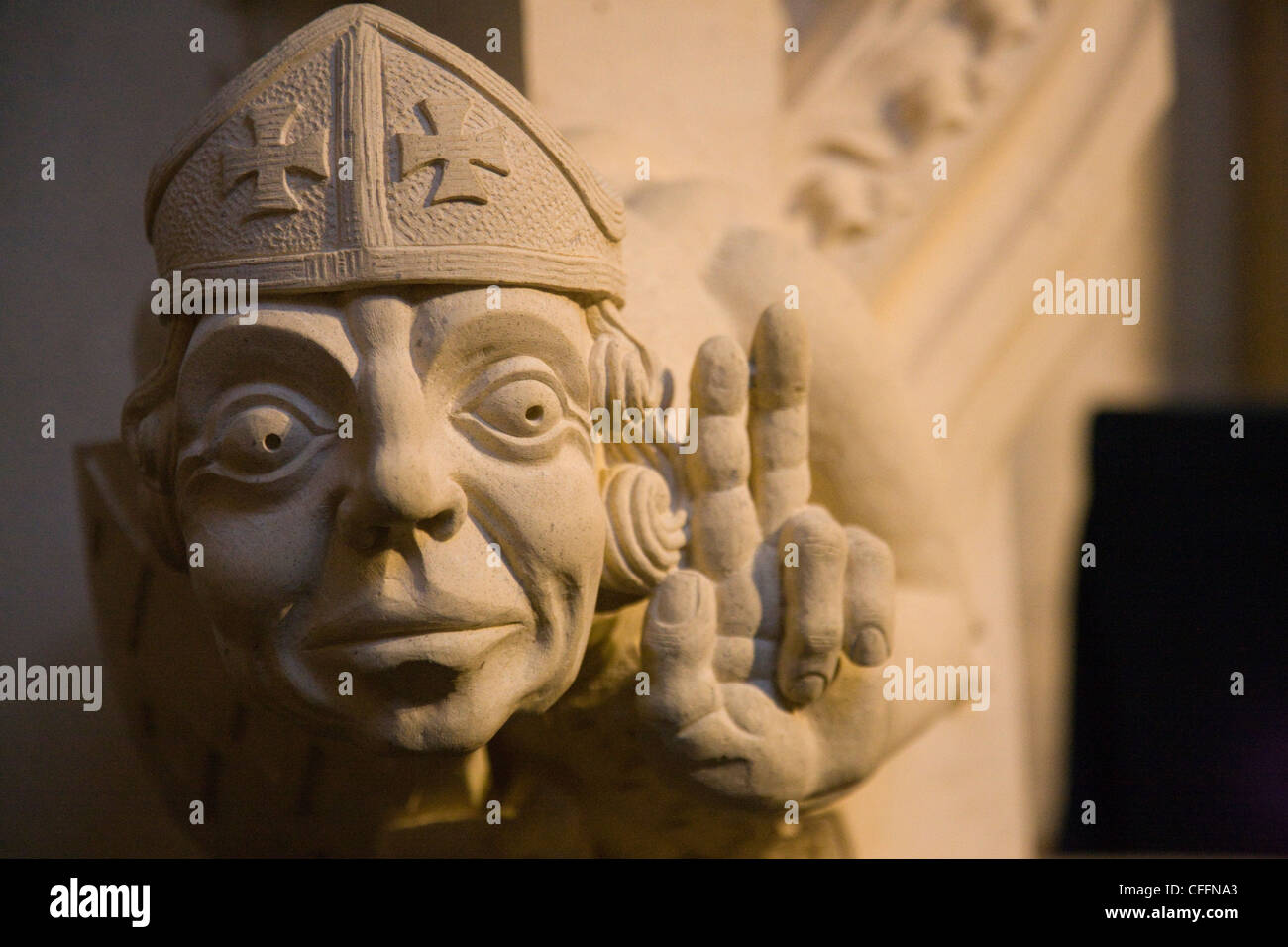 Bishop carved from limestone making two-fingered gesture in York Minster, York Stock Photo
