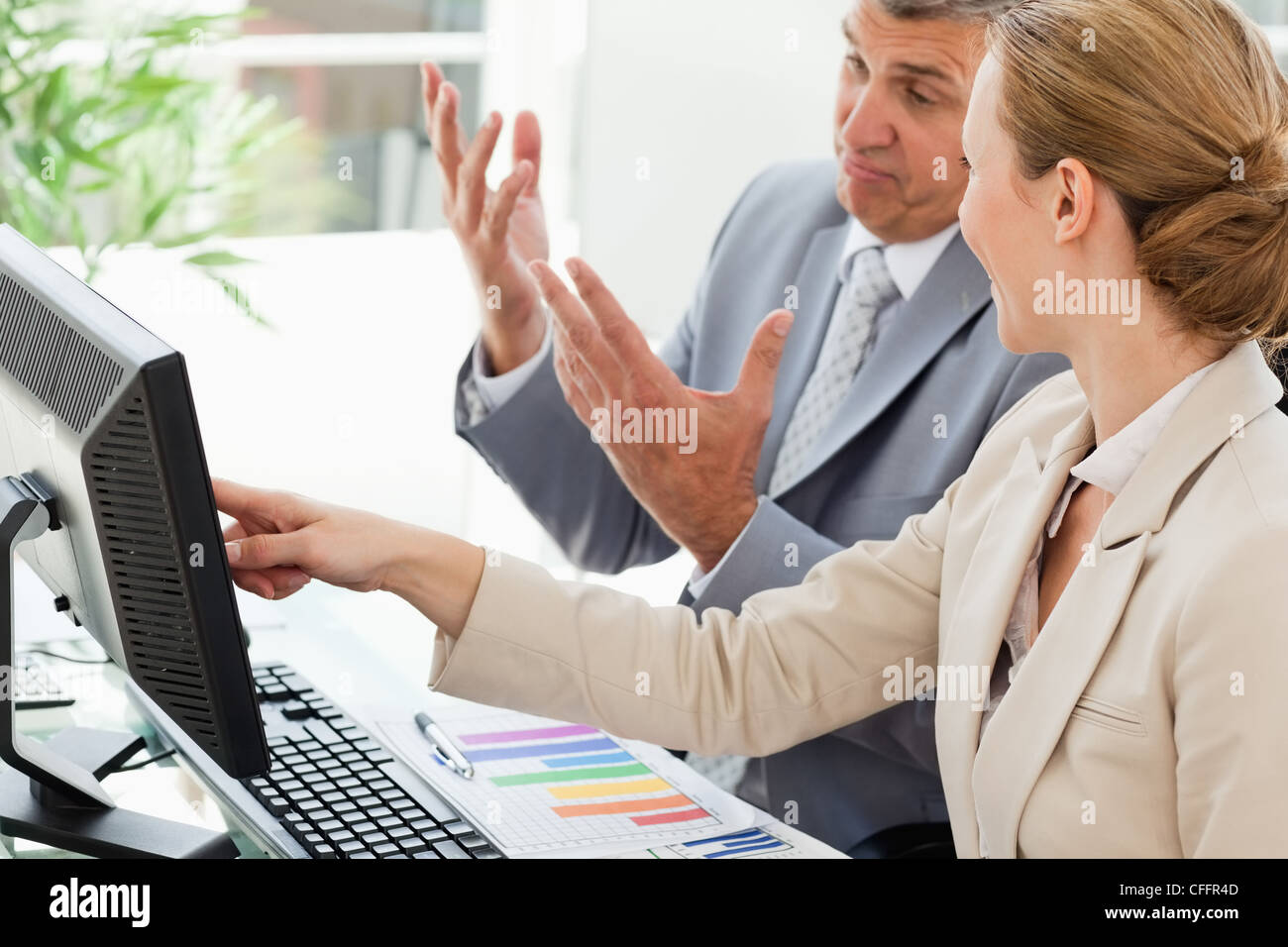 Businessman being corrected by a colleague Stock Photo