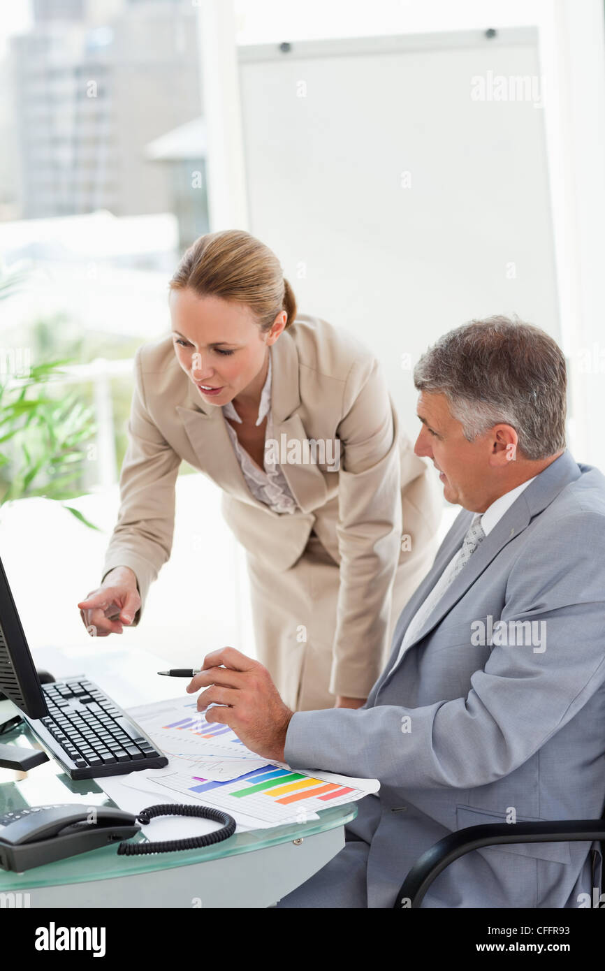 Company people having a conversation about statistic Stock Photo