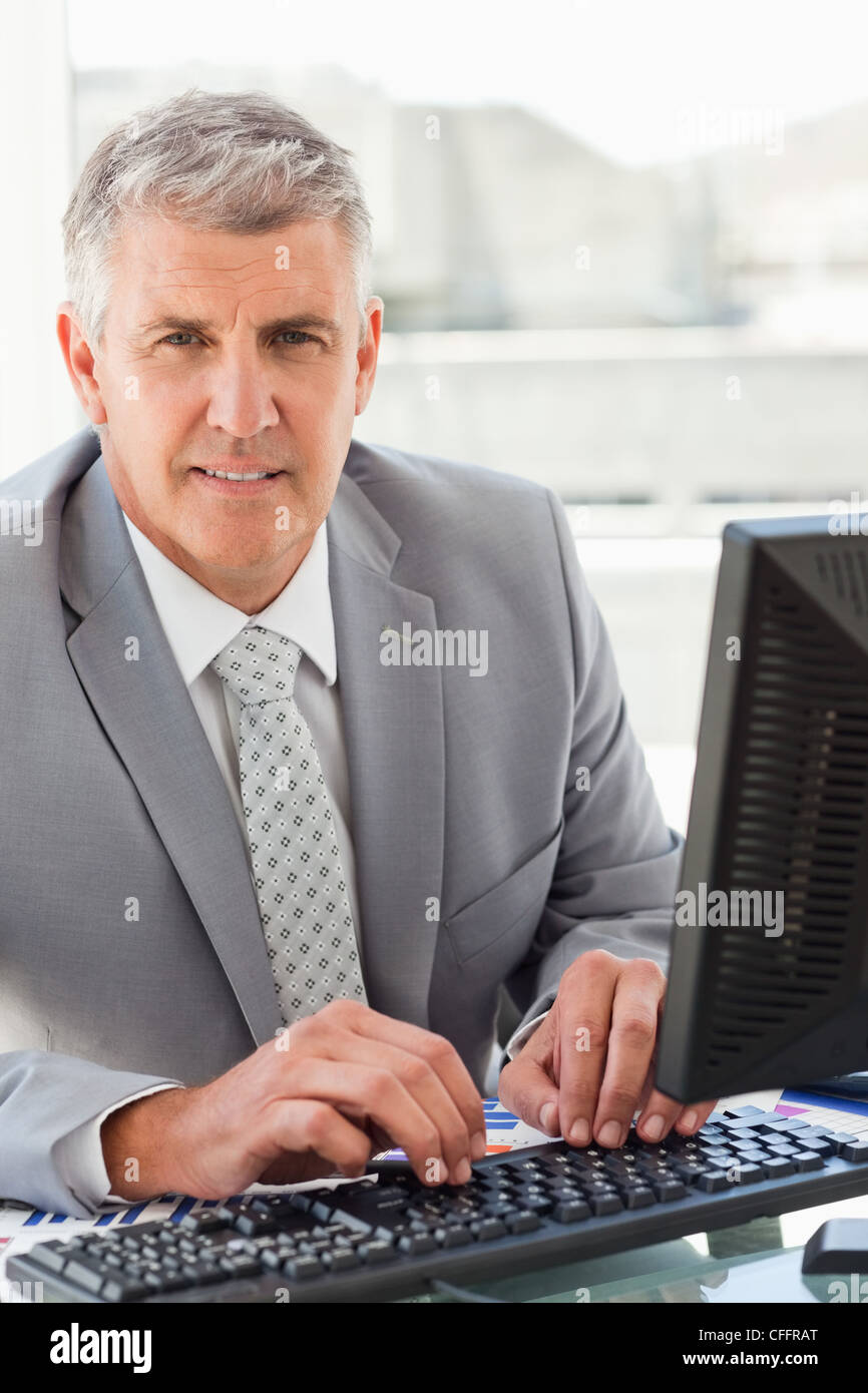 Portrait of a boss working at his desk Stock Photo - Alamy