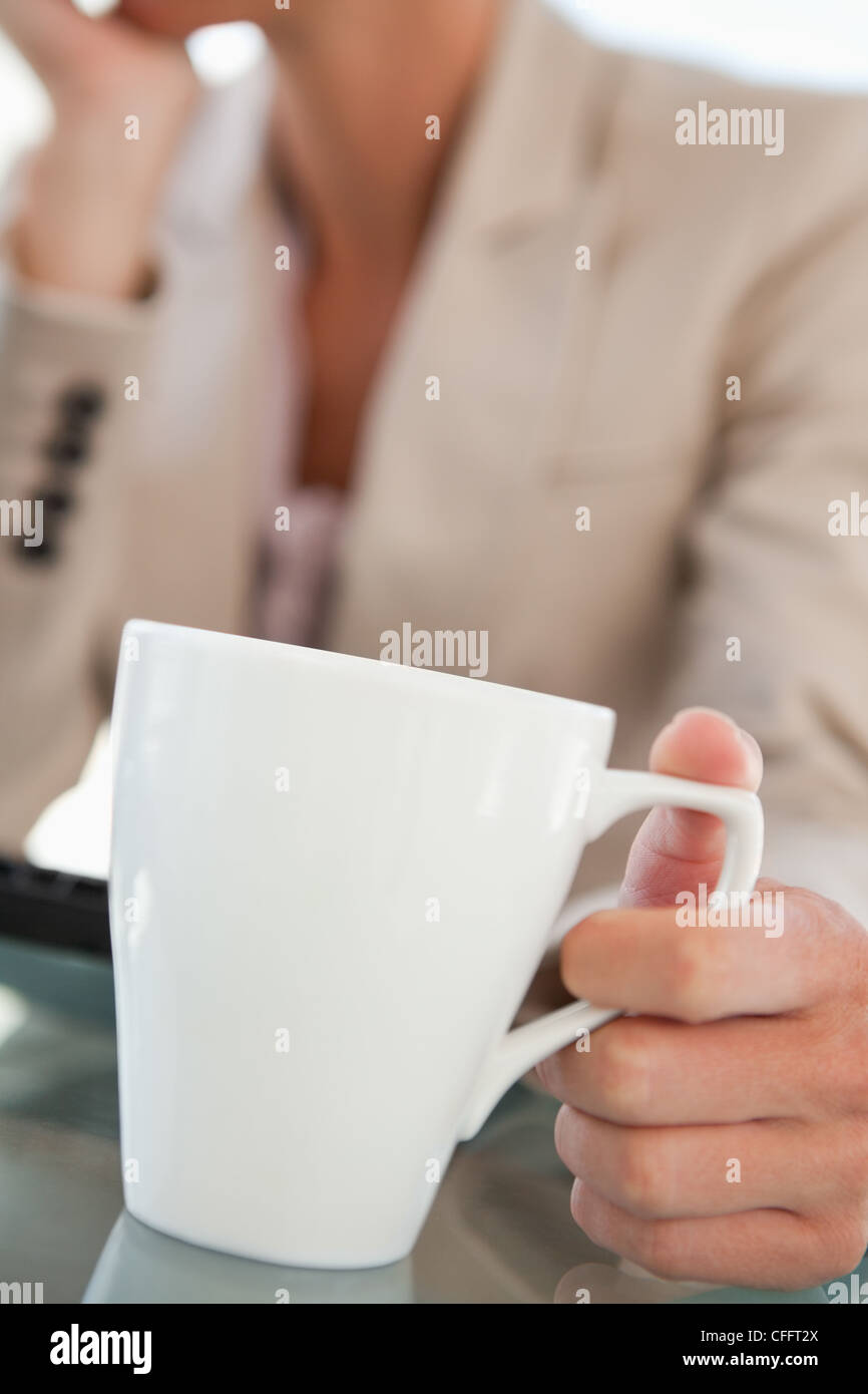 Close-up of a woman's hand taking a white mug Stock Photo