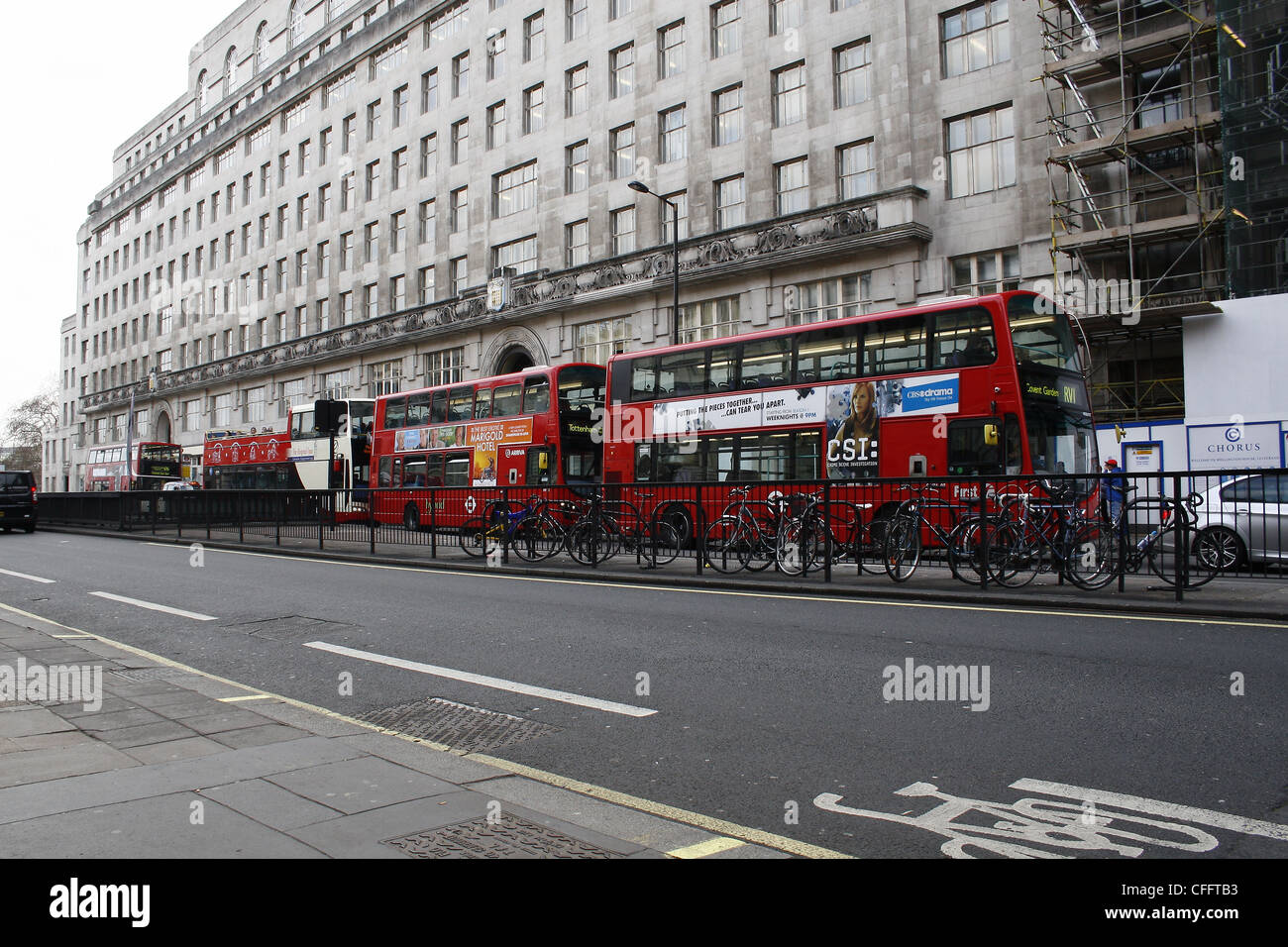 Big Red Buses waiting at traffic lights on Lancaster Place, London, England, UK Stock Photo