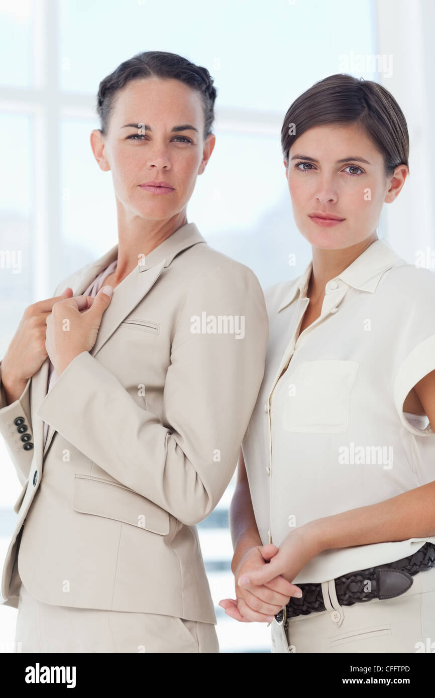 Confident looking businesswomen standing Stock Photo