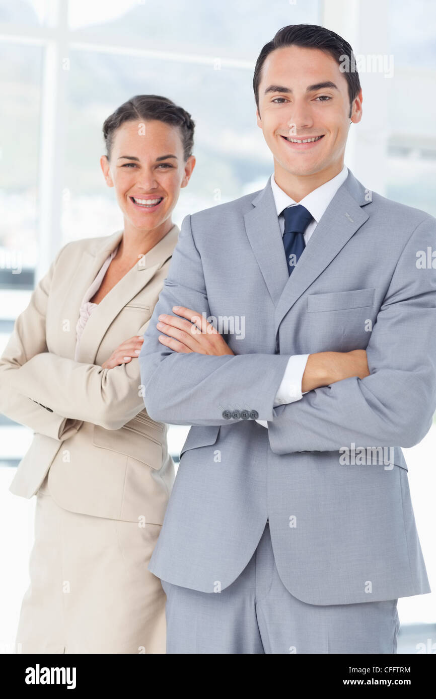 Smiling businesspeople with arms crossed Stock Photo