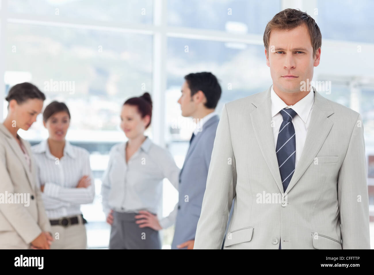 Salesman with colleagues behind him Stock Photo - Alamy