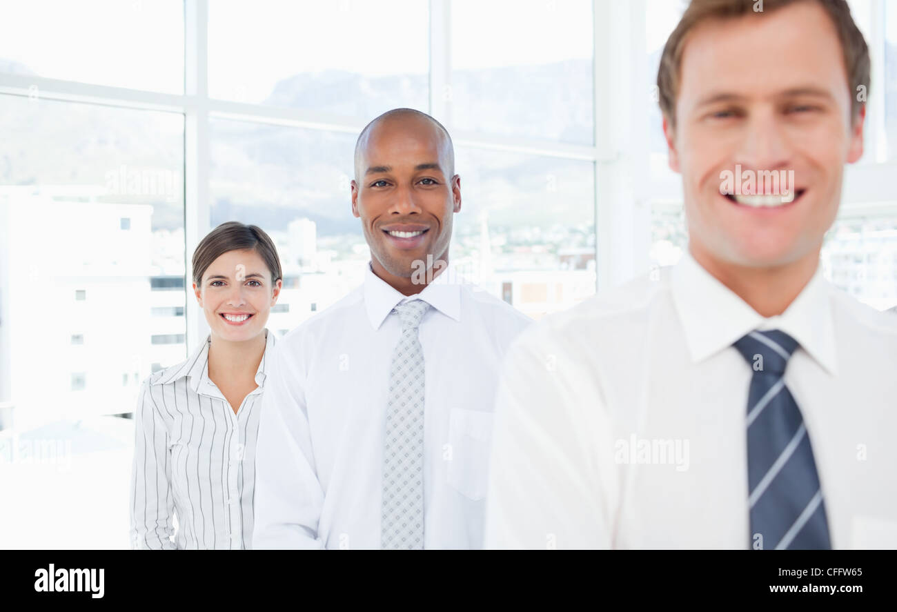Smiling salespeople standing in a line Stock Photo