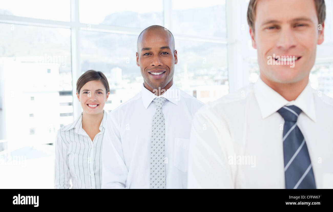 Smiling salespeople standing in a row Stock Photo